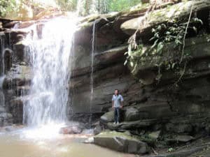 Bruce standing proudly by the waterfall