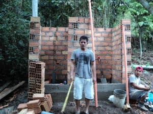 Harry, the work crew captain in front of the bathrooms during construction