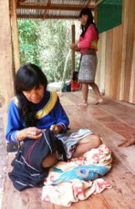 Shipibo Juanita embroidering her cloths	